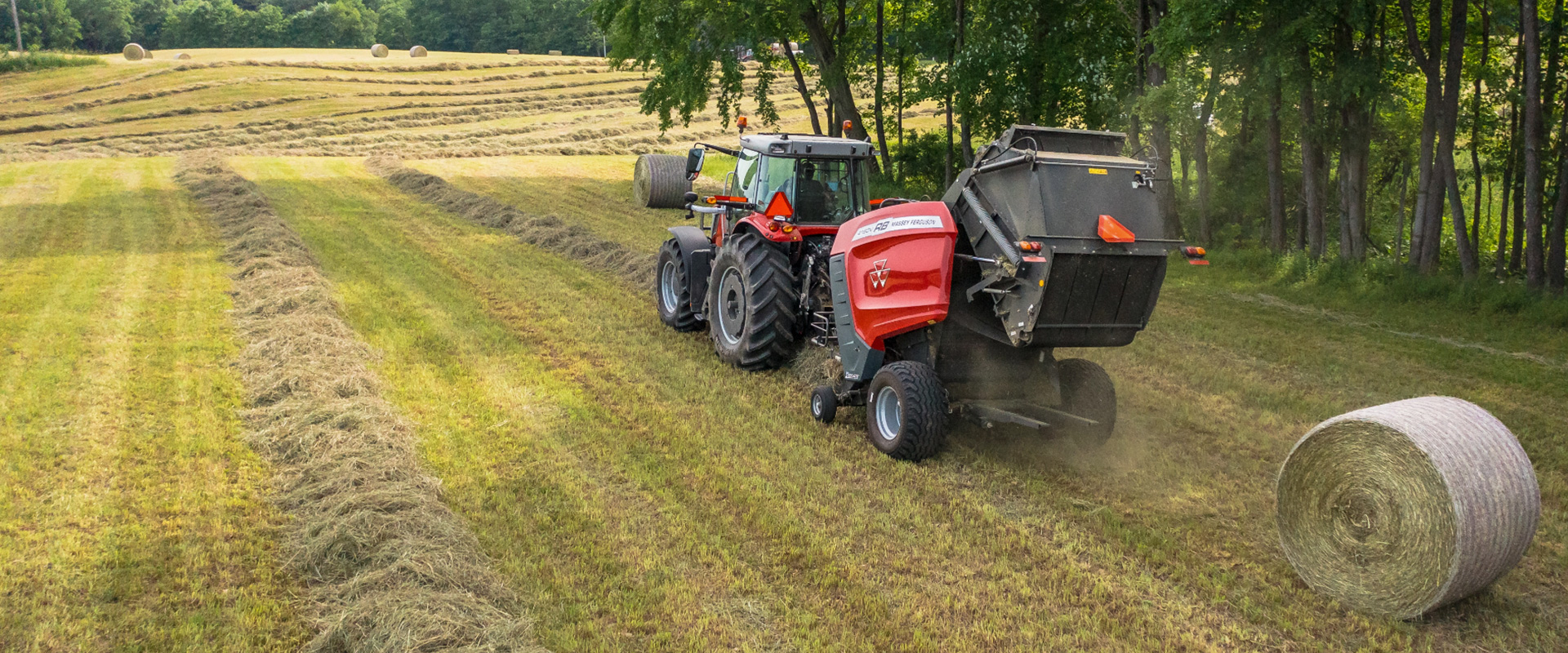 Massey Ferguson baler emptying a twine-wrapped bale.